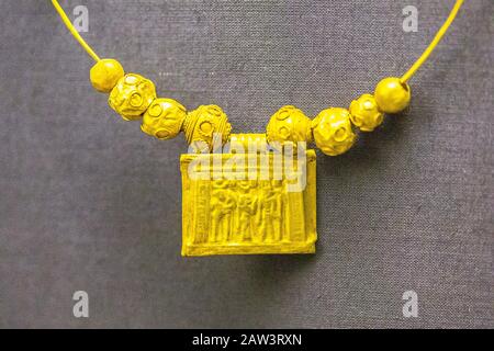 Egypt, Cairo, Egyptian Museum, a pendant, in gold, found in Dendera, Ptolemaic period. It depicts a naos with the theban triad (Amon, Mut, Khonsu). Stock Photo