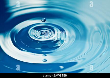 Water drop making a ripple on the surface Stock Photo