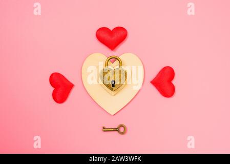 Valentines and love background, a heart-shaped padlock isolated on red background. Stock Photo