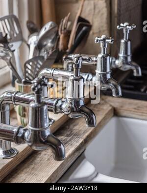 Silver taps over kitchen sink Stock Photo