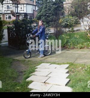An 8 year old girl sitting on her Raleigh Tomahawk bike in 1973 in the suburbs of London UK. Stock Photo