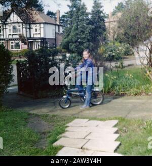 An 8 year old girl sitting on her Raleigh Tomahawk bike in 1973 in the suburbs of London UK. Stock Photo