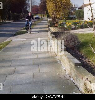 A dad having a ride on his son's new American export Raleigh Chopper bike in 1973 in the suburbs of London UK. Stock Photo