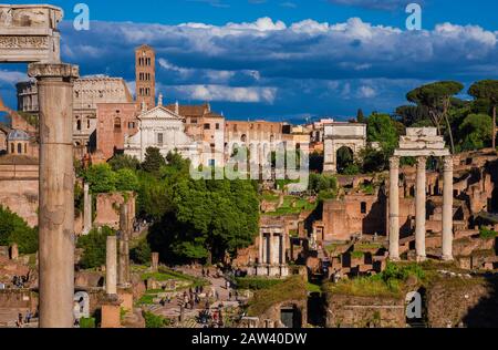 Sightseeing in Rome. Tourists visit Roman Forum ancient ruins Stock Photo