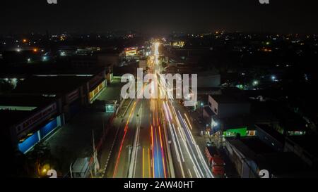 BEKASI. INDONESIA - FEBRUARY 7 2020: light trails on motorway highway at night, long exposure abstract urban background at Bekasi Stock Photo