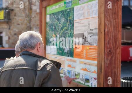 Mar. 19, 2017; Larrabetzu, Bizkaia (Basque Country). Two gentlemen in the informative panel on nature routes in the municipality of Larrabetzu. Stock Photo