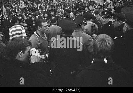Netherlands against Czechoslovakia 1-2  Protesting spectators enter the field Date: November 6, 1966 Location: Amsterdam, Noord-Holland Keywords: caps, policemen, sports, football  :  Unknown / Anefo Copyright Holder: National Archives Material Type: Negative (black / white) archive inventory number: see access 2.24.01.05 Stock Photo