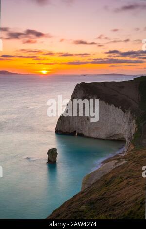 Lulworth, Dorset, UK.  6th February 2020. UK Weather.  A golden sunset at Bats Head near Lulworth in Dorset looking west towards Weymouth and the Isle of Portland viewed from the South West Coast Path on Swyre Head.  Picture Credit: Graham Hunt/Alamy Live News Stock Photo