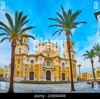 The large Cathedral Square (Plaza de la Catedral) is completely empty in the early morning, the tall bell towers of medieval Cadiz Cathedral are seen Stock Photo