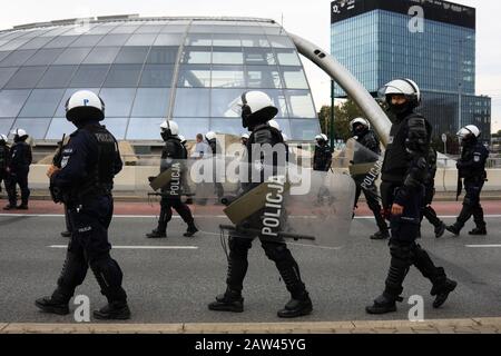 POLAND, CZESTOCHOWA - 16 June 2019: Polish policemen in action protect demonstrating people, white helmets, plastic covers Stock Photo