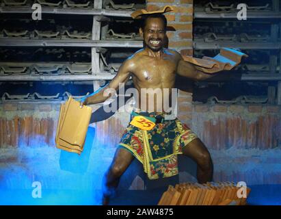 A bodybuilding athlete is showing his body muscles by lifting a number of tiles in a bodybuilding competition between the 2019 Jatiwanggi Cup competition at the Genteng Two Brothers Factory, Jatiwangi, Majalengka, West Java, on Sunday, August 11, 2019. The bodybuilding competition between tile industry companies was initiated as an appreciation for the Genteng Two Brothers Factory, Jatiwangi, Majalengka, West Java, on Sunday, August 11, 2019. tile industry workers. As well as being held to welcome the 74th Indonesian Independence Day. Stock Photo