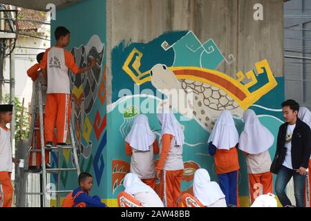 Students seen painting murals at Bandar Lampung flyover, on Thursday, July 18, 2019. 1,500 junior high school students paint murals on 560 poles in welcoming the 337th anniversary of Bandar Lampung and to add to the beauty of the city. Stock Photo