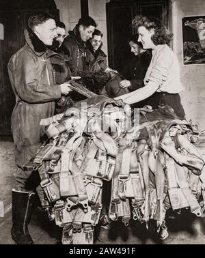 Parachute packers of the WAAF with air crew. The WAAF (Women's Auxiliary Air Force) was created on 28 June 1939,  and women recruited into the WAAF were given basic training. WAAFs did not serve as aircrew, but were active in parachute packing and the crewing of barrage balloons in addition to performing catering, meteorology, radar, aircraft maintenance, transport, communications duties including wireless telephonic and telegraphic operation. Stock Photo