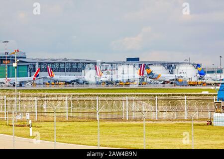 Stuttgart, Germany - April 29, 2017: Airport Stuttgart, planes in front of jet fuel tanks Stock Photo