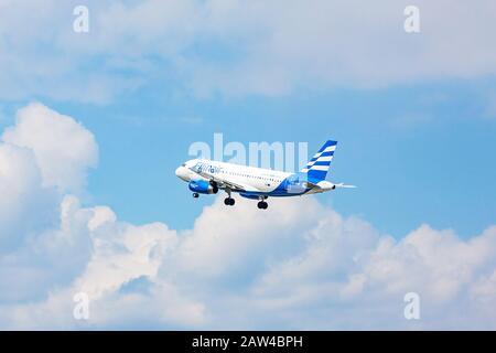 Stuttgart, Germany - April 29, 2017: Airbus airplane from Ellinair while flying - blue sky with clouds Stock Photo