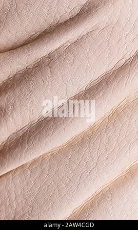 Natural beige leather texture. Useful as background for design-works. Close-up, vertical. Stock Photo