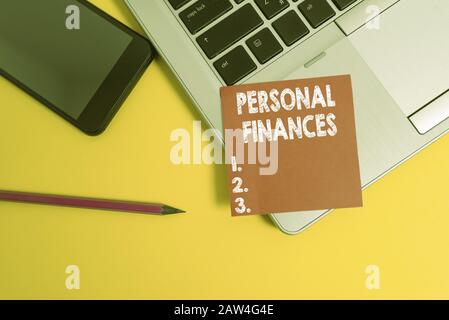 Handwriting text Personal Finances. Conceptual photo the activity of analysing own money and financial decisions Trendy laptop smartphone blank sticky Stock Photo