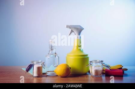 Natural cleaners concept. Natural organic eco friendly home cleaning ingredients, white vinegar, lemon, baking soda, citric acid on wood table with co Stock Photo