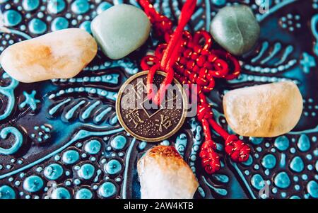 Chinese coin used as Feng Shui money cures attracting the energy of wealth and money concept. Wooden oriental background. Stock Photo