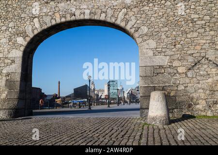 Looking through an old archway over the Salthouse Dock towards the famous Liverpool waterfront. Stock Photo