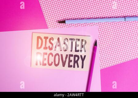 Conceptual hand writing showing Disaster Recovery. Concept meaning helping showing affected by a serious damaging event writing equipments and plain n Stock Photo