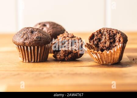 Sweet muffins. Chocolate cupcakes on kitchen table. Stock Photo