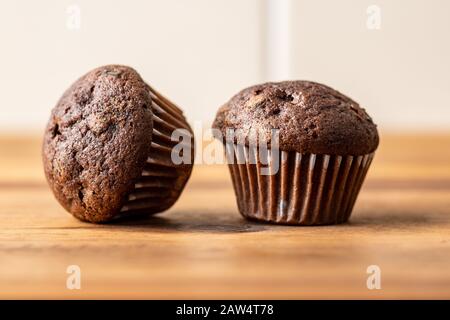 Sweet muffins. Chocolate cupcakes on kitchen table. Stock Photo