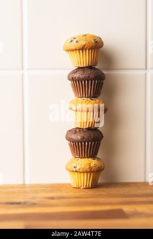 Sweet muffins. Chocolate cupcakes on kitchen table. Stock Photo