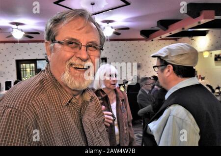 Senior man at family event who is happy and having a fine good time with others of the same group Stock Photo