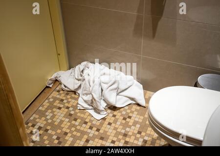 Pile of dirty used towels on the hotel bathroom floor. Housekeeping replace only the used towels on floor with clean ones. Saving water soap energy Stock Photo Alamy