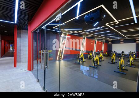 Aerobics spinning indoor bikes gym behind a glass door Stock Photo