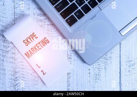 Handwriting text writing Skype Marketing. Conceptual photo apps that specializes in providing video chat and voice Top trendy metallic laptop blank ru Stock Photo