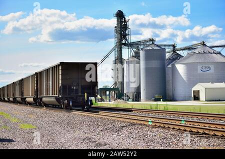 Elburn, Illinois, USA. A Union Pacific freight train passing a large farming cooperative in northeastern Illinois. Stock Photo