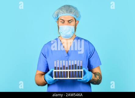 Genetic analysis. Critical number or density of susceptible hosts. Epidemic threshold. Man in medical lab inspecting samples biological material. Epidemic disease. Virus concept. Epidemic infection. Stock Photo