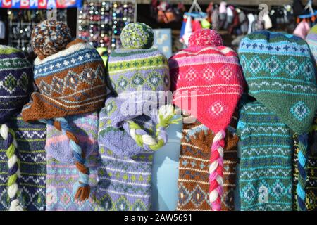 Pile of colorful woolen caps with tassel on a souvenir stand Stock Photo