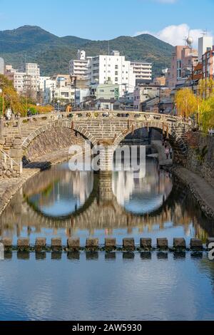 Megane Bridge (Spectacles Bridge) in sunny day with beautiful blue sky reflection on surface. one of the three most famous bridges in Japan