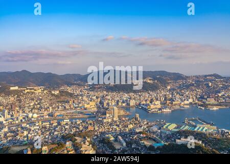 Nagasaki cityscape panorama view from Mt Inasa observation platform deck in sunny day sunset time with blue sky background, famous beauty scenic spot Stock Photo