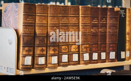 a collection of cyclopedia books placed on a library shelf Stock Photo