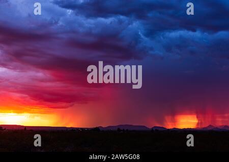 A dramatic, colorful sunset sky with monsoon thunderstorm clouds over Tucson, Arizona Stock Photo