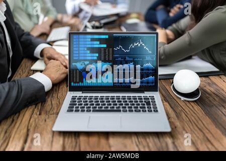 Close-up Of Male And Female Businesspeople In Meeting Discussing Graphs Stock Photo
