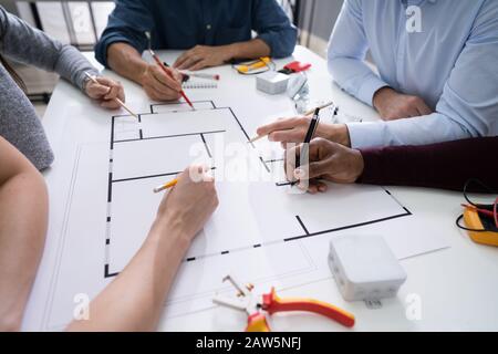 Elevated View Of An Architects Drawing Plan On Blueprint With Electrical Components Stock Photo