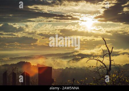 Foggy landscape with sunset in mountains Stock Photo