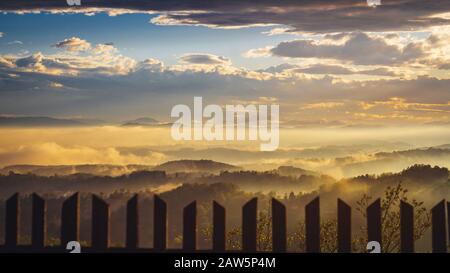 Foggy landscape with sunset in mountains Stock Photo