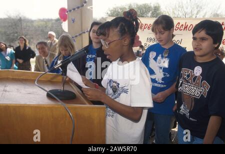 Black female student speaks at  groundbreaking ceremony for additional classrooms at Linder Elementary school in Austin, Texas, financed by local bonds. Stock Photo