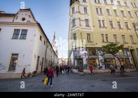 BRNO, CZECHIA - NOVEMBER 5, 2019: People rushing and walking in a pedestrian street of Brno, Orli Ulice, surrounded by shops and boutiques in the city Stock Photo