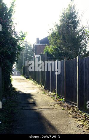A leafy footpath and wooden fence, Edgware, Middlesex, England, UK. Stock Photo