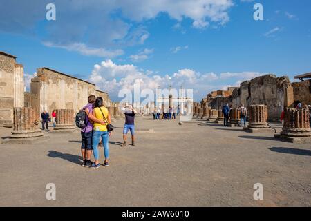 Overtourism, Pompeii ruins, tourists visiting and taking pictures at Pompeii Basilica, ancient city of Pompeii, Italy, Europe Stock Photo