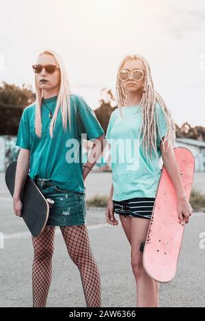 Two young skateboarder woman posing Stock Photo