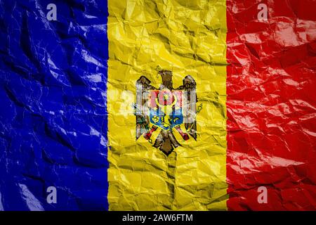 National flag of Moldova on crumpled paper. Flag printed on a sheet. Flag image for design on flyers, advertising. Stock Photo