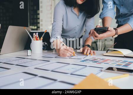 Programmer and UX UI designer working in a software development and coding technologies. Mobile and website design and programing development technolo Stock Photo
